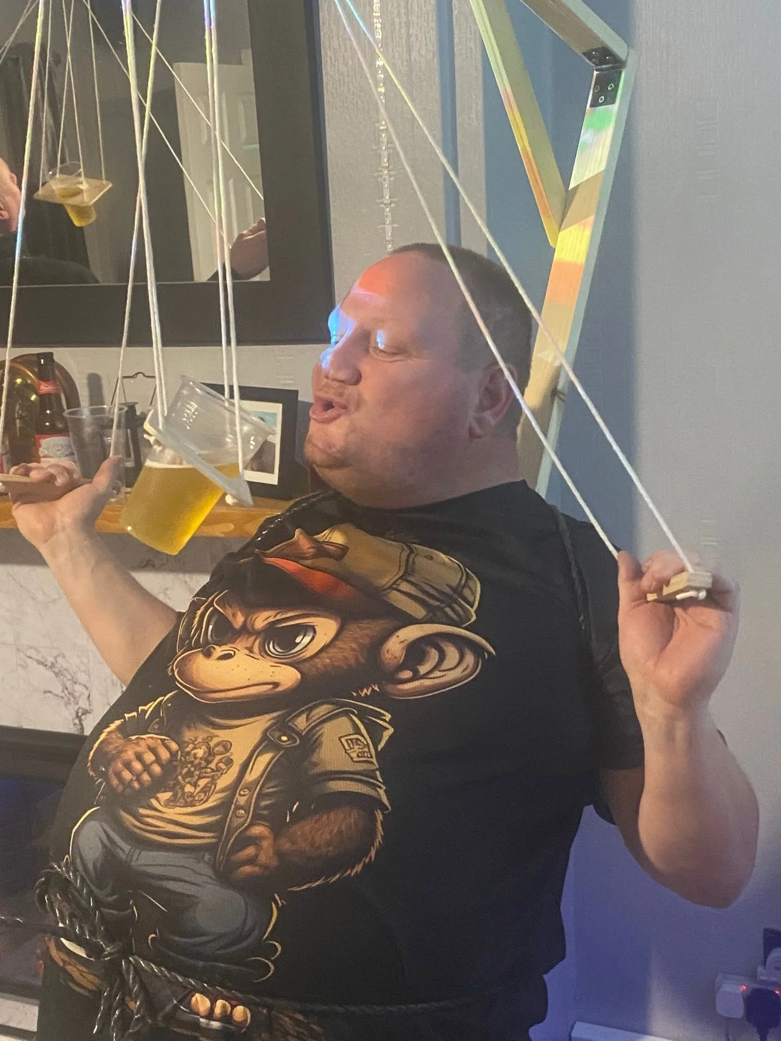 A man carefully guiding his drink with the Beer Puppeteer controls