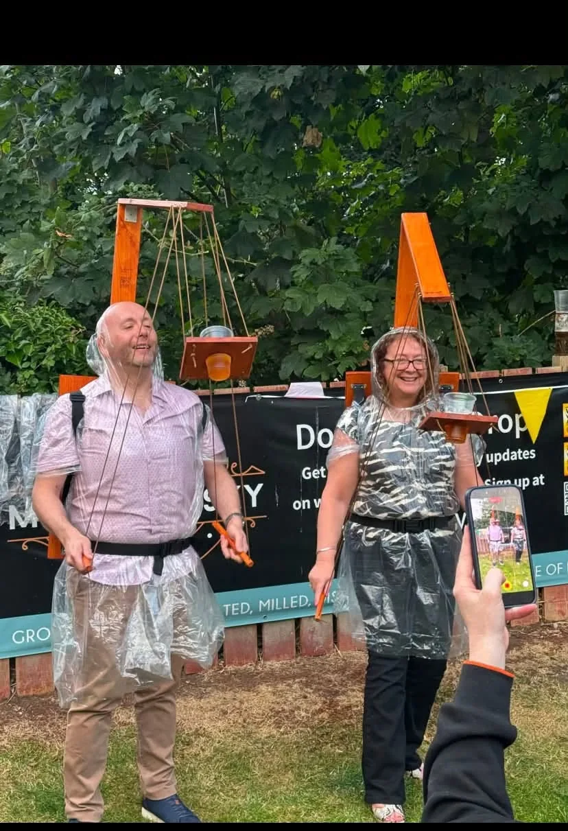 Two people laughing while using Beer Puppeteer frames
